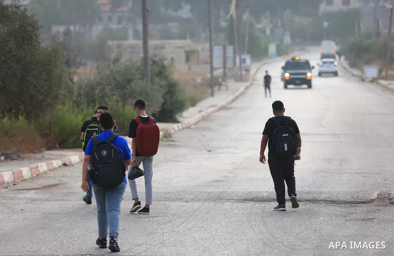 Palestinian students walk to their schools of the first day of the new year study, in al-Lubban al-Sharqiya village, south of Nablus city, in the West Bank on August 29, 2022. Attacks on education by Israeli military for...