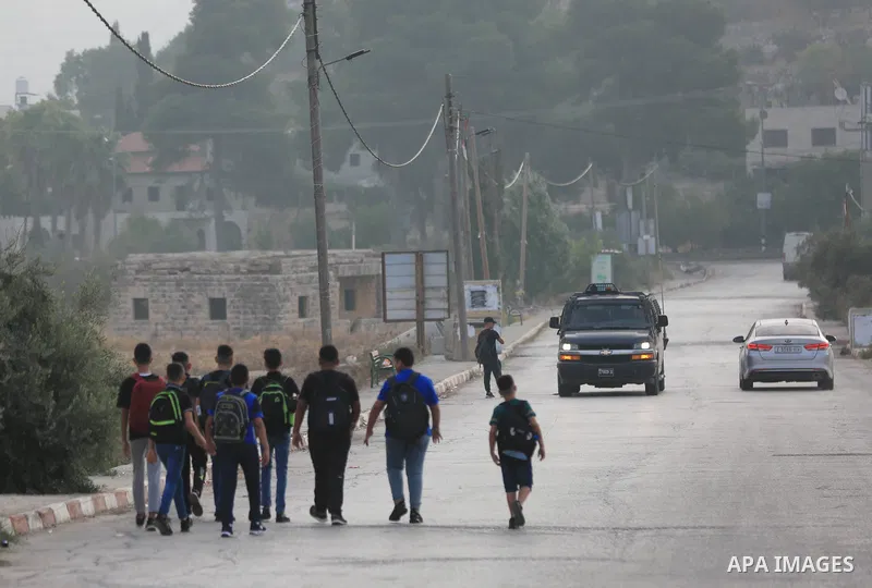 Palestinian students walk to their schools of the first day of the new year study, in al-Lubban al-Sharqiya village, south of Nablus city, in the West Bank on August 29, 2022. Attacks on education by Israeli military for...
