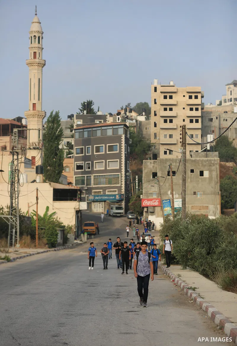 Palestinian students walk to their schools of the first day of the new year study, in al-Lubban al-Sharqiya village, south of Nablus city, in the West Bank on August 29, 2022. Attacks on education by Israeli military for...