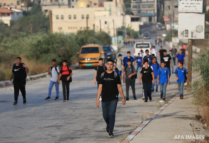 Palestinian students walk to their schools of the first day of the new year study, in al-Lubban al-Sharqiya village, south of Nablus city, in the West Bank on August 29, 2022. Attacks on education by Israeli military for...
