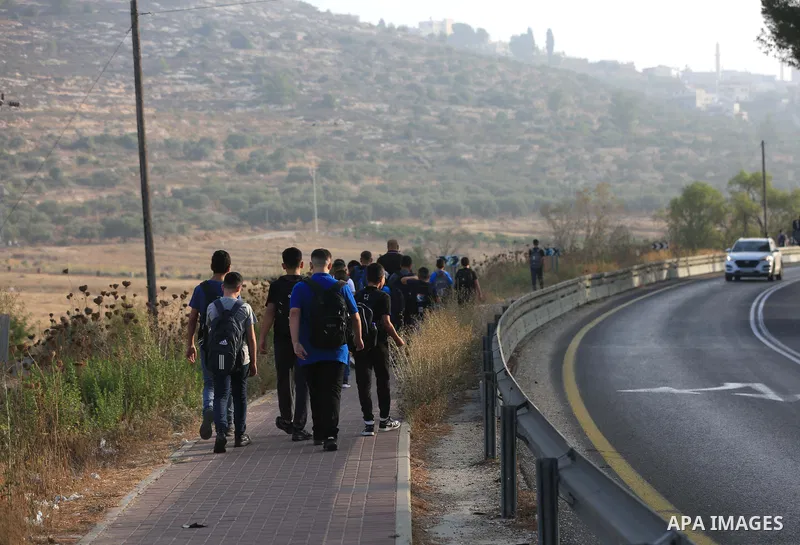 Palestinian students walk to their schools of the first day of the new year study, in al-Lubban al-Sharqiya village, south of Nablus city, in the West Bank on August 29, 2022. Attacks on education by Israeli military for...