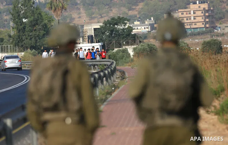 Palestinian students walk to their schools of the first day of the new year study, in al-Lubban al-Sharqiya village, south of Nablus city, in the West Bank on August 29, 2022. Attacks on education by Israeli military for...