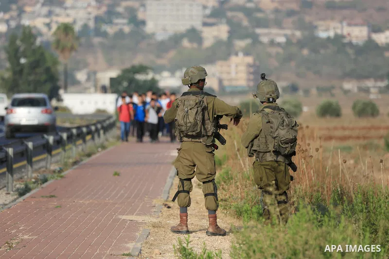 Palestinian students walk to their schools of the first day of the new year study, in al-Lubban al-Sharqiya village, south of Nablus city, in the West Bank on August 29, 2022. Attacks on education by Israeli military for...