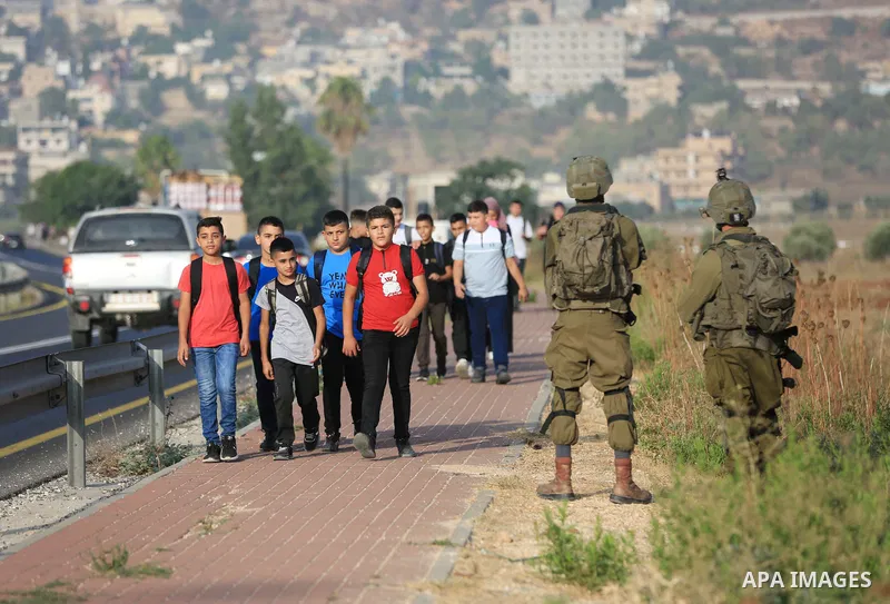 Palestinian students walk to their schools of the first day of the new year study, in al-Lubban al-Sharqiya village, south of Nablus city, in the West Bank on August 29, 2022. Attacks on education by Israeli military for...