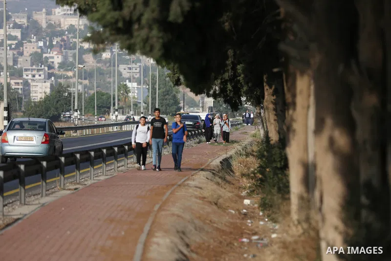 Palestinian students walk to their schools of the first day of the new year study, in al-Lubban al-Sharqiya village, south of Nablus city, in the West Bank on August 29, 2022. Attacks on education by Israeli military for...
