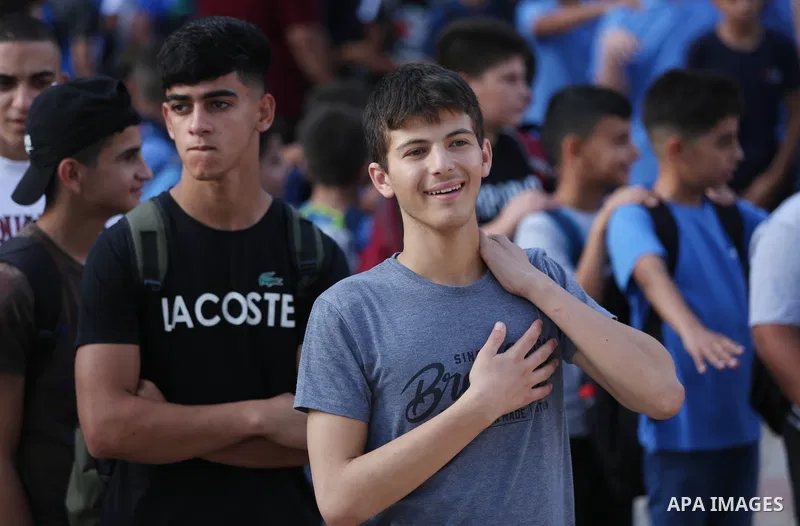 Palestinian students walk to their schools of the first day of the new year study, in al-Lubban al-Sharqiya village, south of Nablus city, in the West Bank on August 29, 2022. Attacks on education by Israeli military for...
