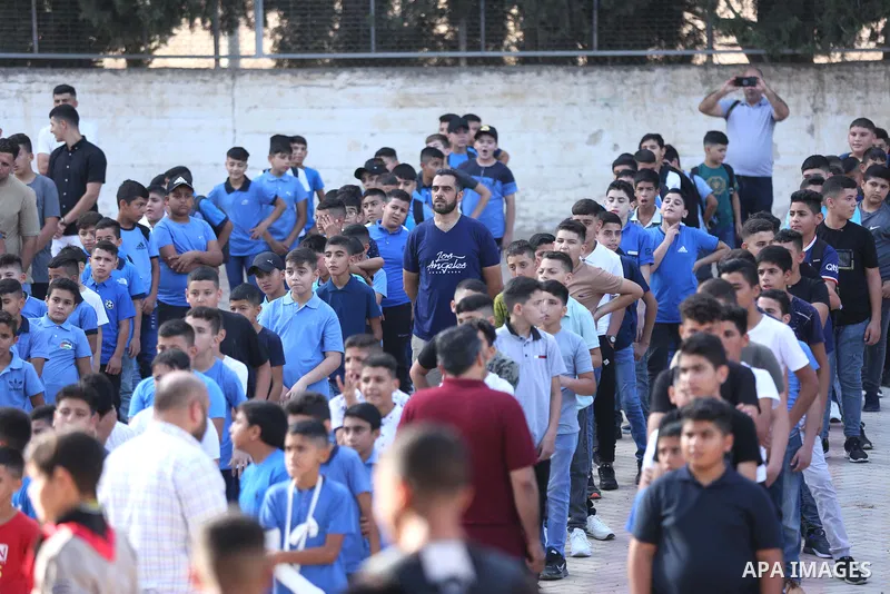 Palestinian students walk to their schools of the first day of the new year study, in al-Lubban al-Sharqiya village, south of Nablus city, in the West Bank on August 29, 2022. Attacks on education by Israeli military for...