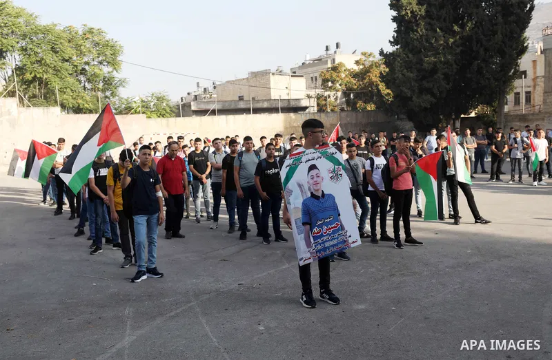 Classmates of Palestinian Hussein Taha, who was killed by Israeli forces on August 9, mourn his death on the first day of school after the summer holiday, in the West Bank city of Nablus. The Palestinian Ministry of Educ...