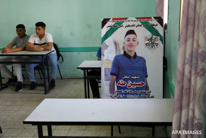 Classmates of Palestinian Hussein Taha, who was killed by Israeli forces on August 9, mourn his death on the first day of school after the summer holiday, in the West Bank city of Nablus. The Palestinian Ministry of Educ...