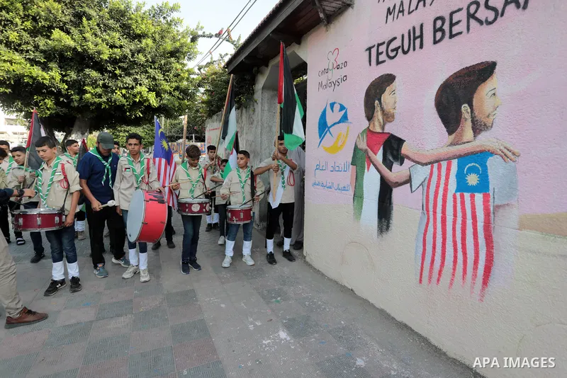 Palestinians attend the opening of a mural on the occasion of Malaysian National Day, in Gaza City on August 30, 2022. Malaysia's Independence Day is celebrated on August 31st. Also known as Merdeka Day (Freedom Day), th...