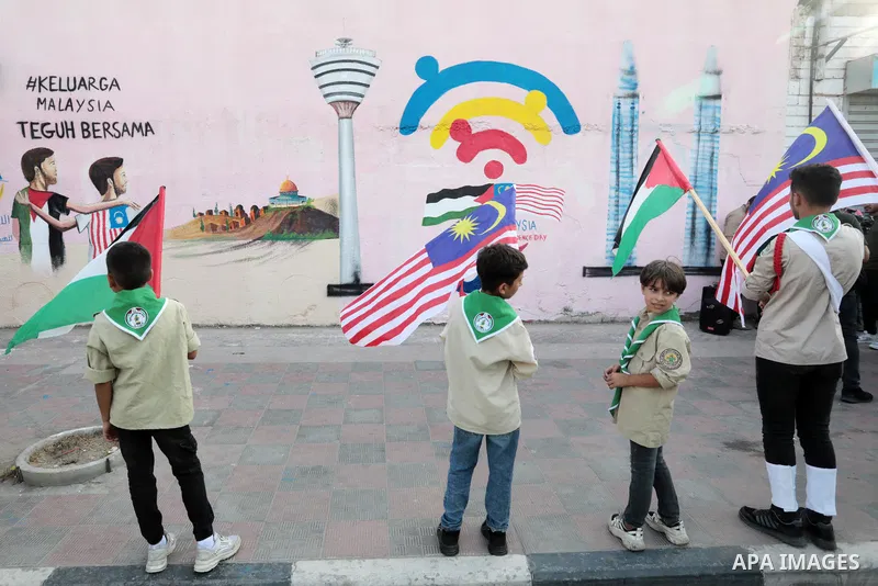 Palestinians attend the opening of a mural on the occasion of Malaysian National Day, in Gaza City on August 30, 2022. Malaysia's Independence Day is celebrated on August 31st. Also known as Merdeka Day (Freedom Day), th...