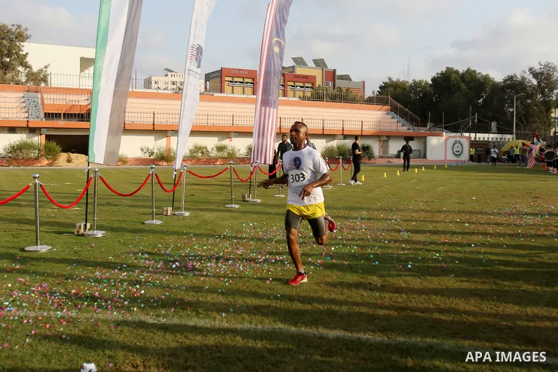 Palestinian runners participate in the Freedom Marathon on the occasion of Malaysian National Day, in Gaza city on August 31, 2022. Malaysia's Independence Day is celebrated on August 31st. Also known as Merdeka Day (Fre...