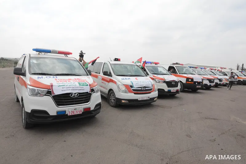 Palestinian ambulance drivers take part in a protest are called upon to pressure the Israeli to allow the free movement of patients through the Beit Hanoun checkpoint in front of the Erez Crossing in Beit Hanoun in the n...