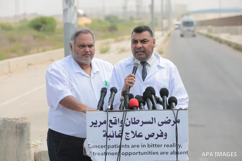 Palestinian ambulance drivers take part in a protest are called upon to pressure the Israeli to allow the free movement of patients through the Beit Hanoun checkpoint in front of the Erez Crossing in Beit Hanoun in the n...