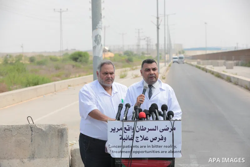 Palestinian ambulance drivers take part in a protest are called upon to pressure the Israeli to allow the free movement of patients through the Beit Hanoun checkpoint in front of the Erez Crossing in Beit Hanoun in the n...
