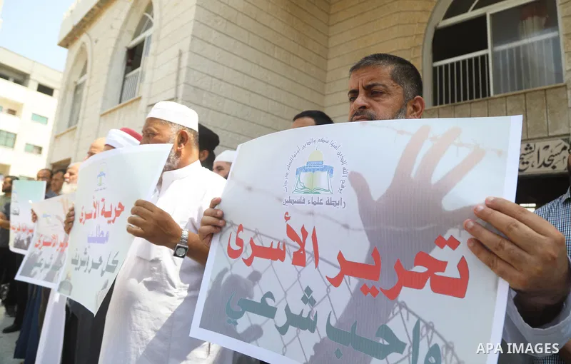 Members of the Palestine Scholars Association take part in a protest in solidarity with prisoners on hunger strike in Israeli jails, in front of Red Cross office, in Gaza city on August 31, 2022. There are currently 4500...