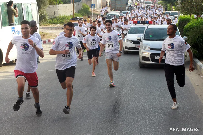 Palestinian runners participate in the Freedom Marathon on the occasion of Malaysian National Day, in Gaza city on August 31, 2022. Malaysia's Independence Day is celebrated on August 31st. Also known as Merdeka Day (Fre...