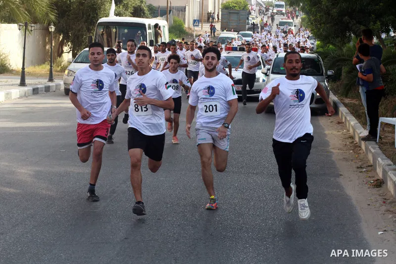 Palestinian runners participate in the Freedom Marathon on the occasion of Malaysian National Day, in Gaza city on August 31, 2022. Malaysia's Independence Day is celebrated on August 31st. Also known as Merdeka Day (Fre...