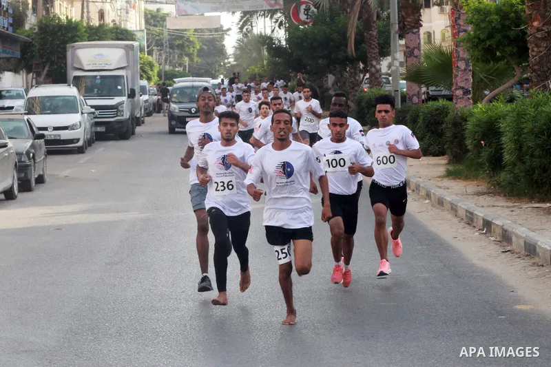 Palestinian runners participate in the Freedom Marathon on the occasion of Malaysian National Day, in Gaza city on August 31, 2022. Malaysia's Independence Day is celebrated on August 31st. Also known as Merdeka Day (Fre...