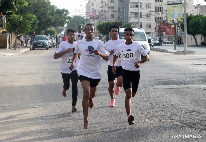Palestinian runners participate in the Freedom Marathon on the occasion of Malaysian National Day, in Gaza city on August 31, 2022. Malaysia's Independence Day is celebrated on August 31st. Also known as Merdeka Day (Fre...
