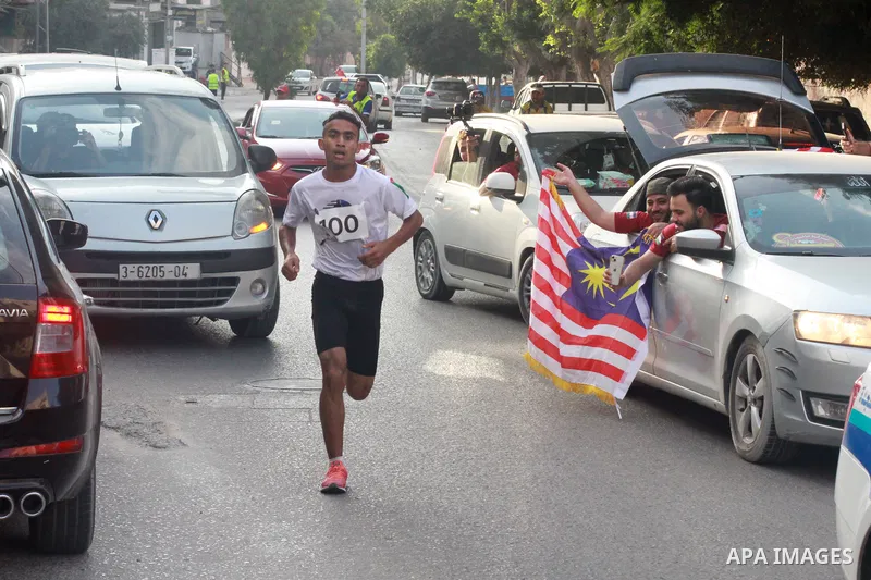 Palestinian runners participate in the Freedom Marathon on the occasion of Malaysian National Day, in Gaza city on August 31, 2022. Malaysia's Independence Day is celebrated on August 31st. Also known as Merdeka Day (Fre...