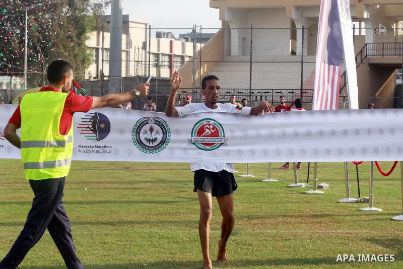 Palestinian runners participate in the Freedom Marathon on the occasion of Malaysian National Day, in Gaza city on August 31, 2022. Malaysia's Independence Day is celebrated on August 31st. Also known as Merdeka Day (Fre...