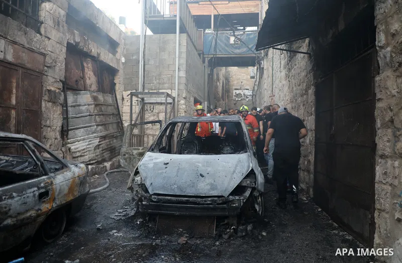 Palestinians inspect burnt-out cars during an Israeli military operation in the West Bank city of Nablus on July 24, 2022. Clashes between Israeli security forces and Palestinian have broken out in the city of Nablus in...