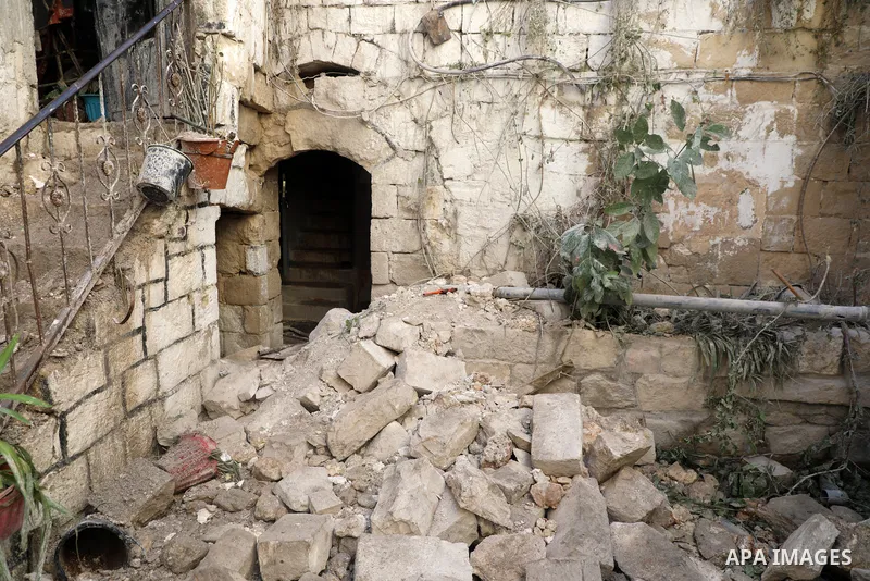 Palestinians inspect the damage to the house of Palestinian Mohammad Al-Azizi that was demolished by Israeli troops, in the West Bank city of Nablus on July 24, 2022. Clashes between Israeli security forces and Palestini...