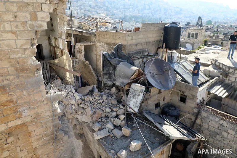 Palestinians inspect the damage to the house of Palestinian Mohammad Al-Azizi that was demolished by Israeli troops, in the West Bank city of Nablus on July 24, 2022. Clashes between Israeli security forces and Palestini...