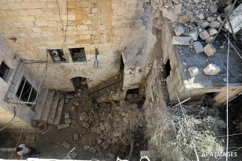 Palestinians inspect the damage to the house of Palestinian Mohammad Al-Azizi that was demolished by Israeli troops, in the West Bank city of Nablus on July 24, 2022. Clashes between Israeli security forces and Palestini...