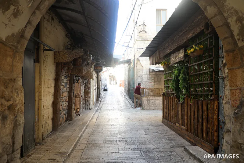 Palestinians walk near closed shops during a general strike, after Israeli forces killed Two Palestinians, in the West Bank city of Nablus on July 24, 2022. Two Palestinians were shot dead last night and ten others wound...