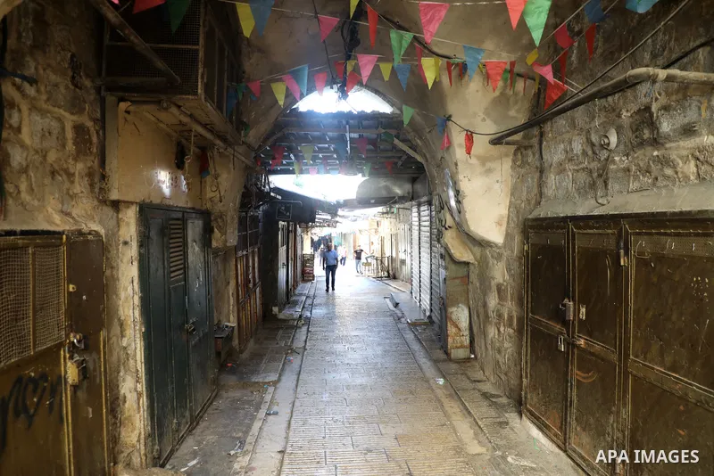 Palestinians walk near closed shops during a general strike, after Israeli forces killed Two Palestinians, in the West Bank city of Nablus on July 24, 2022. Two Palestinians were shot dead last night and ten others wound...