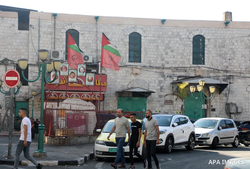 Palestinians walk near closed shops during a general strike, after Israeli forces killed Two Palestinians, in the West Bank city of Nablus on July 24, 2022. Two Palestinians were shot dead last night and ten others wound...