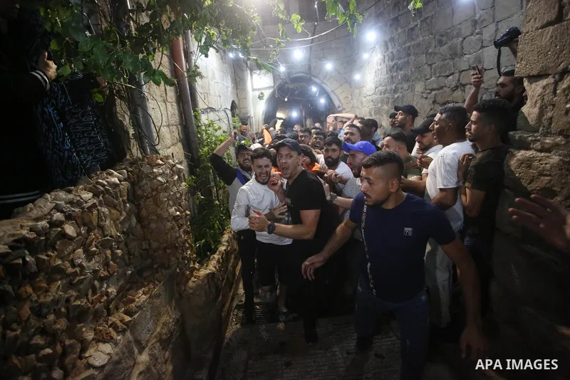 Relatives of Palestinians Mohammad Al-Azizi and Abboud Sobh, who were killed by Israeli forces, mourn during their funeral in the West Bank city of Nablus on July 24, 2022. Israeli troops killed Two Palestinian civilian...