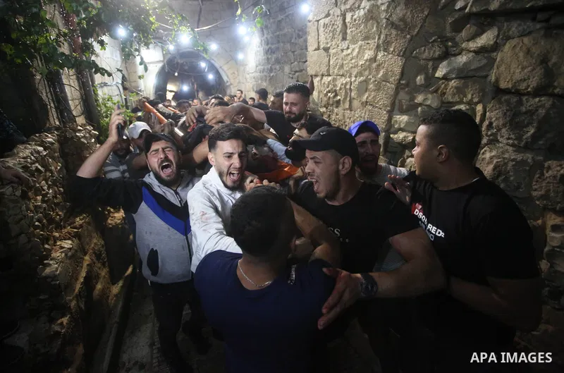 Relatives of Palestinians Mohammad Al-Azizi and Abboud Sobh, who were killed by Israeli forces, mourn during their funeral in the West Bank city of Nablus on July 24, 2022. Israeli troops killed Two Palestinian civilian...