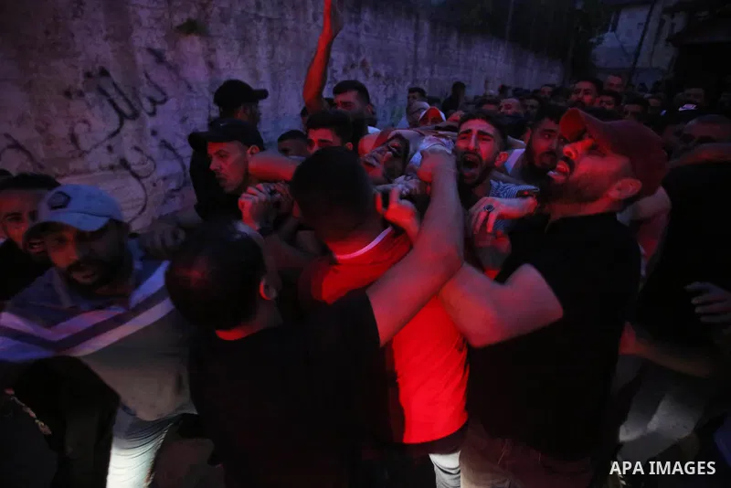 Relatives of Palestinians Mohammad Al-Azizi and Abboud Sobh, who were killed by Israeli forces, mourn during their funeral in the West Bank city of Nablus on July 24, 2022. Israeli troops killed Two Palestinian civilian...