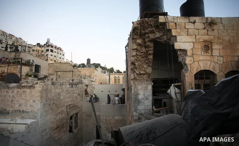 Palestinians inspect the damage to the house of Palestinian Mohammad Al-Azizi that was demolished by Israeli troops, in the West Bank city of Nablus on July 24, 2022. Clashes between Israeli security forces and Palestini...