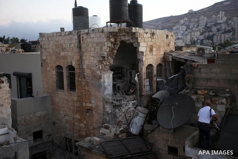 Palestinians inspect the damage to the house of Palestinian Mohammad Al-Azizi that was demolished by Israeli troops, in the West Bank city of Nablus on July 24, 2022. Clashes between Israeli security forces and Palestini...