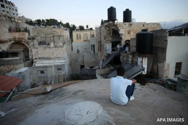 Palestinians inspect the damage to the house of Palestinian Mohammad Al-Azizi that was demolished by Israeli troops, in the West Bank city of Nablus on July 24, 2022. Clashes between Israeli security forces and Palestini...