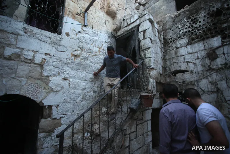 Palestinians inspect the damage to the house of Palestinian Mohammad Al-Azizi that was demolished by Israeli troops, in the West Bank city of Nablus on July 24, 2022. Clashes between Israeli security forces and Palestini...