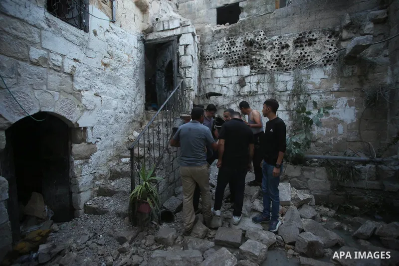 Palestinians inspect the damage to the house of Palestinian Mohammad Al-Azizi that was demolished by Israeli troops, in the West Bank city of Nablus on July 24, 2022. Clashes between Israeli security forces and Palestini...