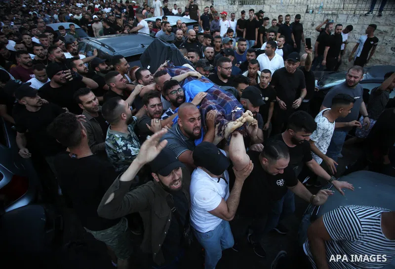 Relatives of Palestinians Mohammad Al-Azizi and Abboud Sobh, who were killed by Israeli forces, mourn during their funeral in the West Bank city of Nablus on July 24, 2022. Israeli troops killed Two Palestinian civilian...
