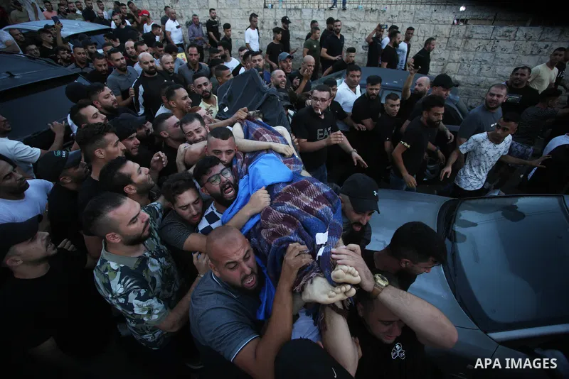 Relatives of Palestinians Mohammad Al-Azizi and Abboud Sobh, who were killed by Israeli forces, mourn during their funeral in the West Bank city of Nablus on July 24, 2022. Israeli troops killed Two Palestinian civilian...