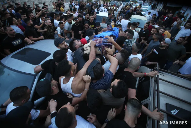 Relatives of Palestinians Mohammad Al-Azizi and Abboud Sobh, who were killed by Israeli forces, mourn during their funeral in the West Bank city of Nablus on July 24, 2022. Israeli troops killed Two Palestinian civilian...