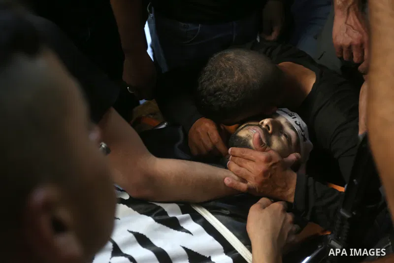Mourners carry the bodies of two Palestinians who were killed by Israeli forces, during their funeral, in the West Bank city of Nablus on July 24, 2022. Two Palestinians were shot dead last night and ten others wounded,...