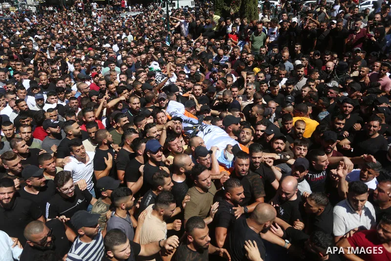 Mourners carry the bodies of two Palestinians who were killed by Israeli forces, during their funeral, in the West Bank city of Nablus on July 24, 2022. Two Palestinians were shot dead last night and ten others wounded,...