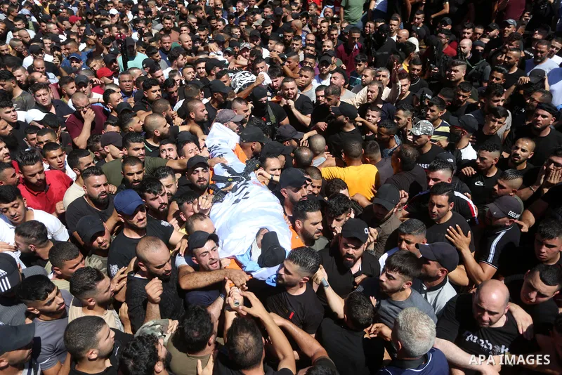 Mourners carry the bodies of two Palestinians who were killed by Israeli forces, during their funeral, in the West Bank city of Nablus on July 24, 2022. Two Palestinians were shot dead last night and ten others wounded,...