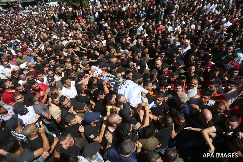 Mourners carry the bodies of two Palestinians who were killed by Israeli forces, during their funeral, in the West Bank city of Nablus on July 24, 2022. Two Palestinians were shot dead last night and ten others wounded,...