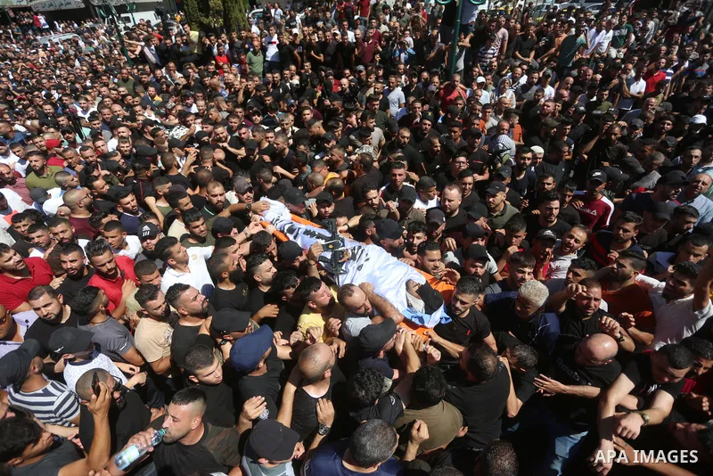 Mourners carry the bodies of two Palestinians who were killed by Israeli forces, during their funeral, in the West Bank city of Nablus on July 24, 2022. Two Palestinians were shot dead last night and ten others wounded,...