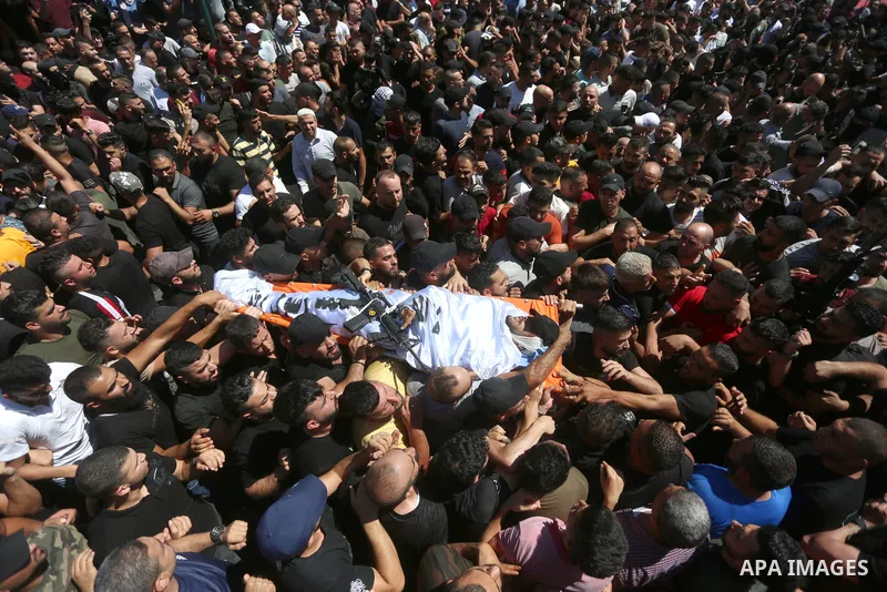 Mourners carry the bodies of two Palestinians who were killed by Israeli forces, during their funeral, in the West Bank city of Nablus on July 24, 2022. Two Palestinians were shot dead last night and ten others wounded,...